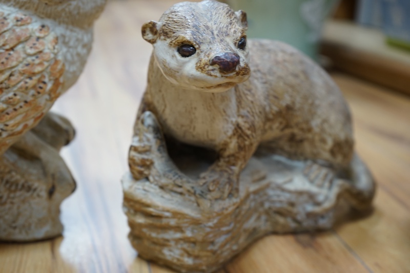 Audrey Carter, three studio pottery animal models, an owl, otter and badger, 37cm. Condition - good